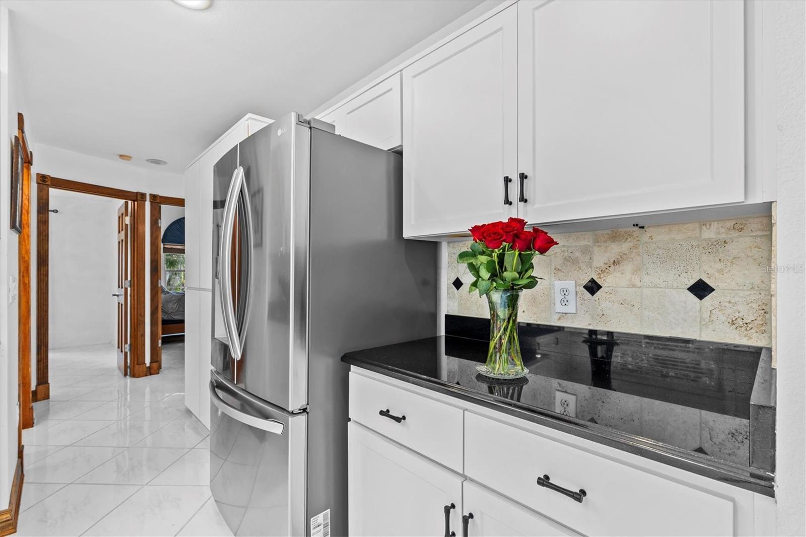 Pantry area is to the left of the refrigerator.