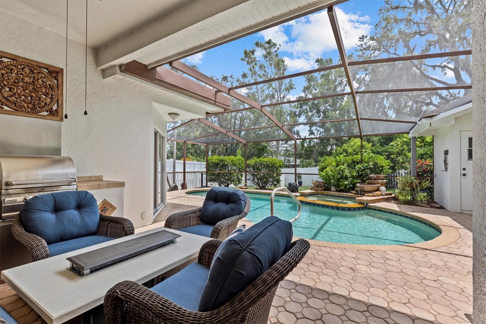 Beautiful view from your covered and screened lanai, with a heated pool and spa.