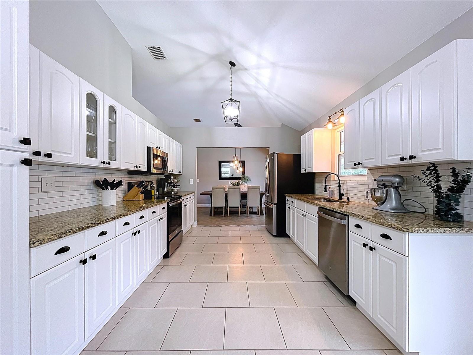 Expansive kitchen layout with abundant counter space and dual prep zones, ideal for home chefs or everyday convenience.