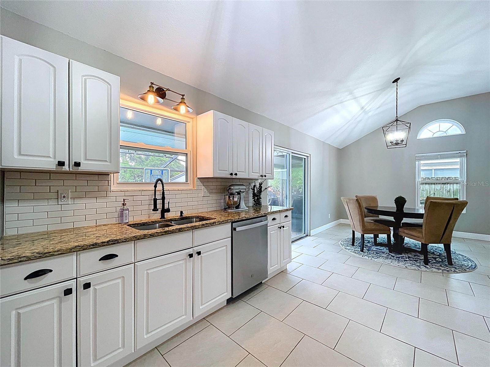 This extended kitchen space includes a sunny breakfast nook with sliding doors to the lanai, making casual dining and indoor-outdoor living a breeze.