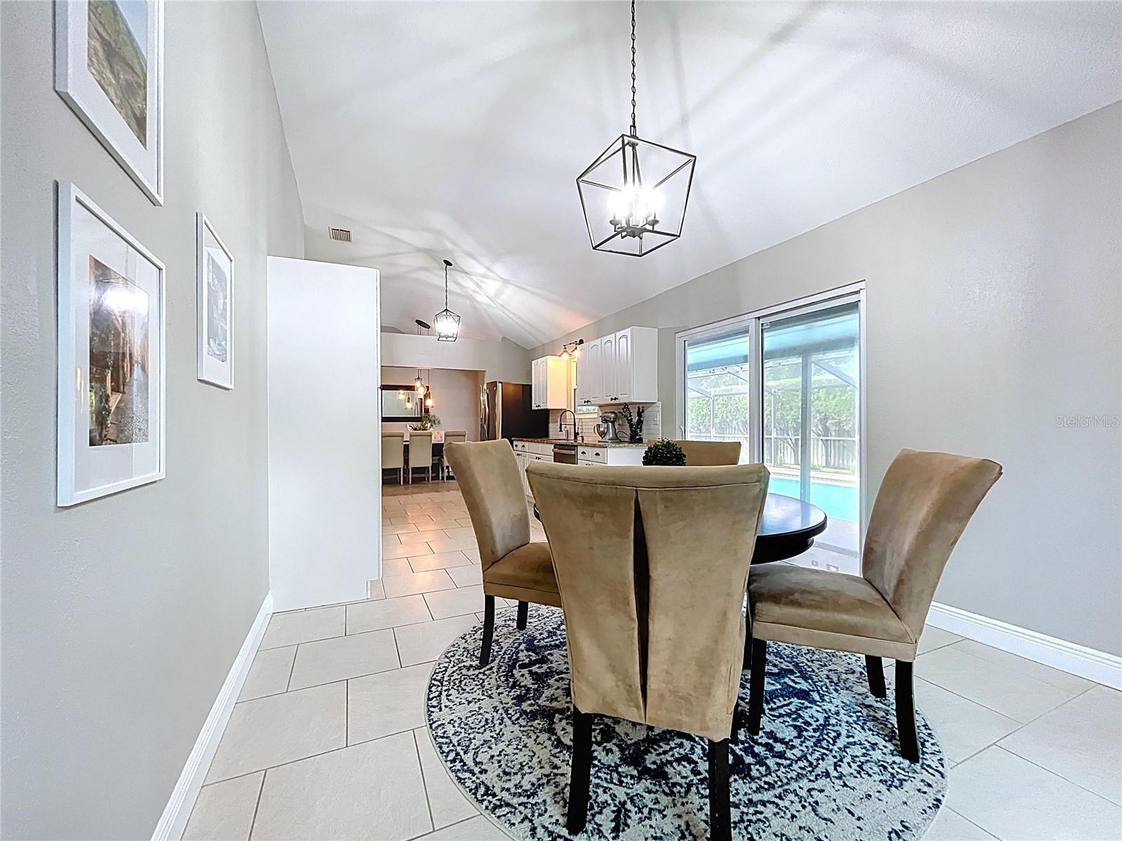Framed by natural light and wall art, this breakfast space is ideal for casual dining with family or guests.