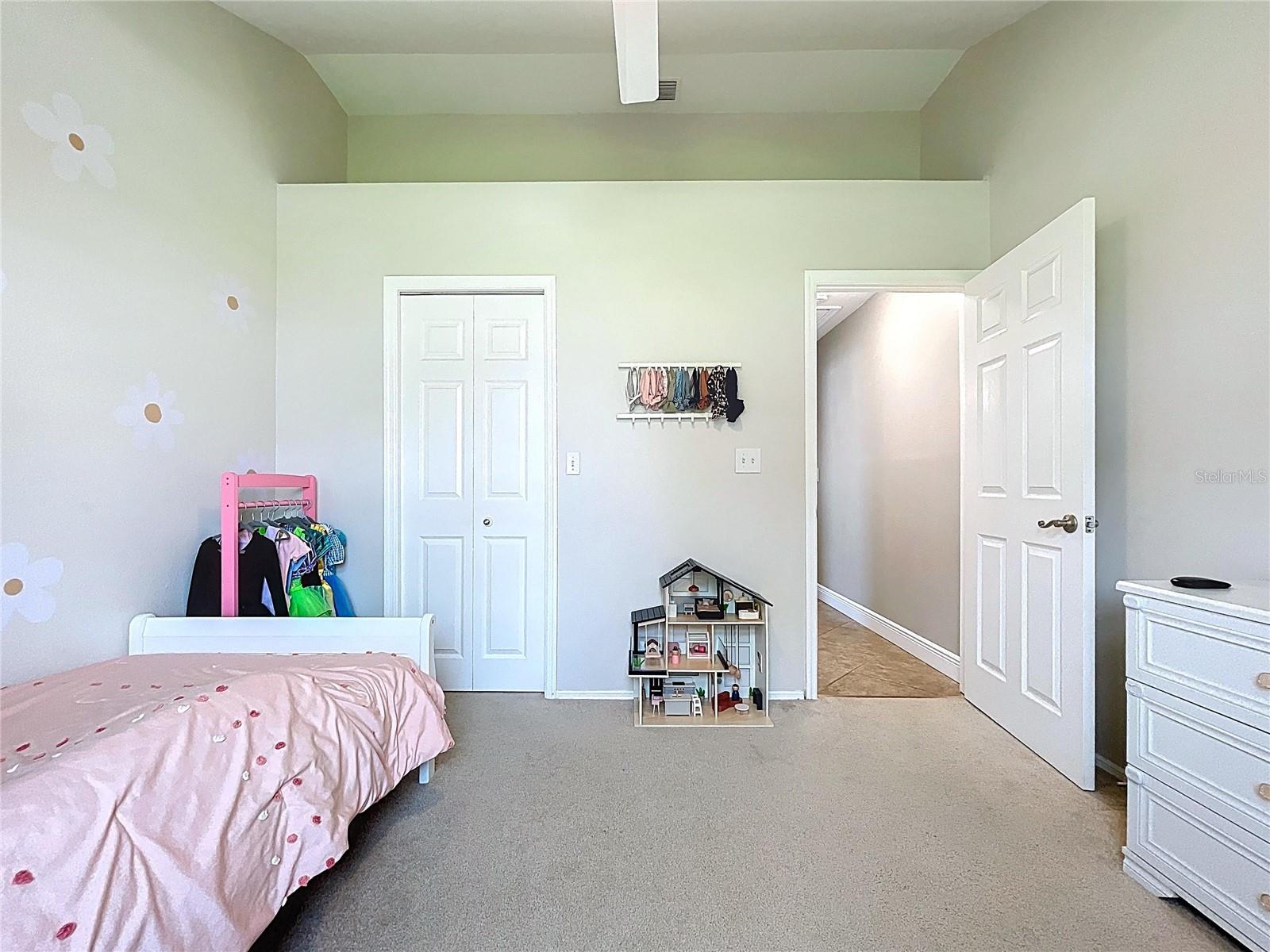 Ample closet space and neutral tones make this room versatile for any need, from playroom to private retreat.