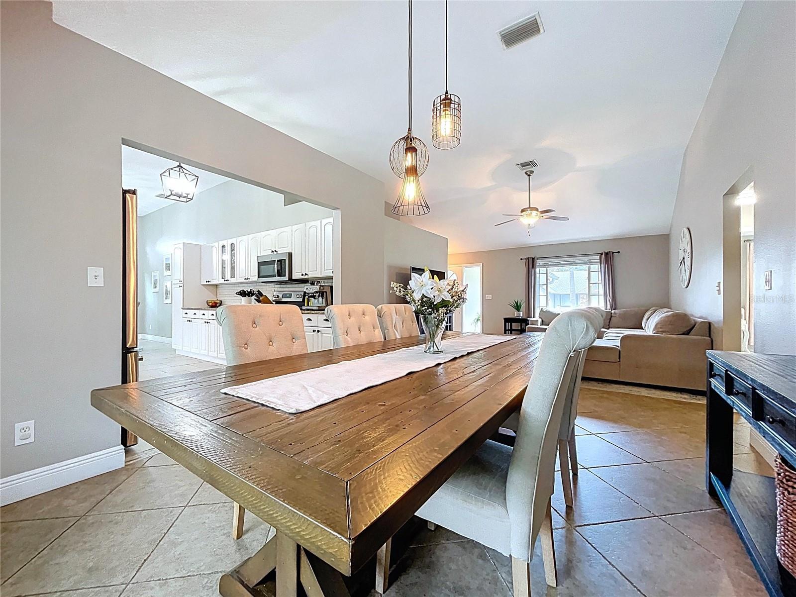 Open-concept view showing the easy transition from dining to kitchen, emphasizing the home’s functional layout and visual connectivity.