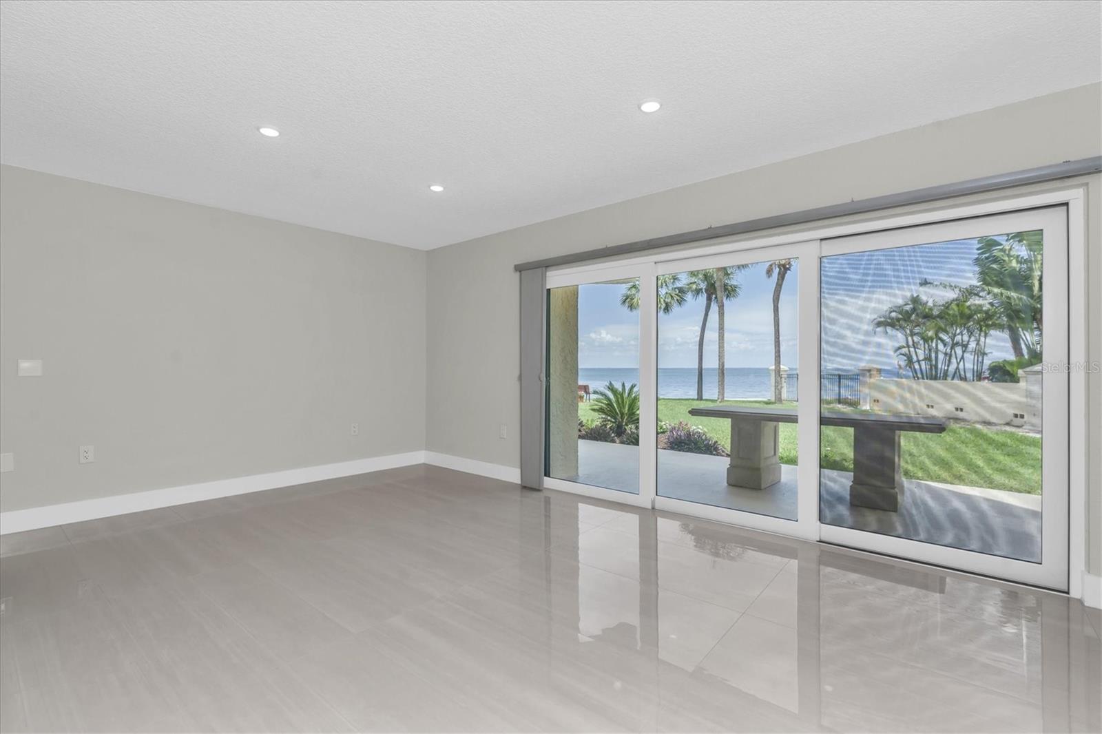 Primary bedroom with impact sliders leading to patio