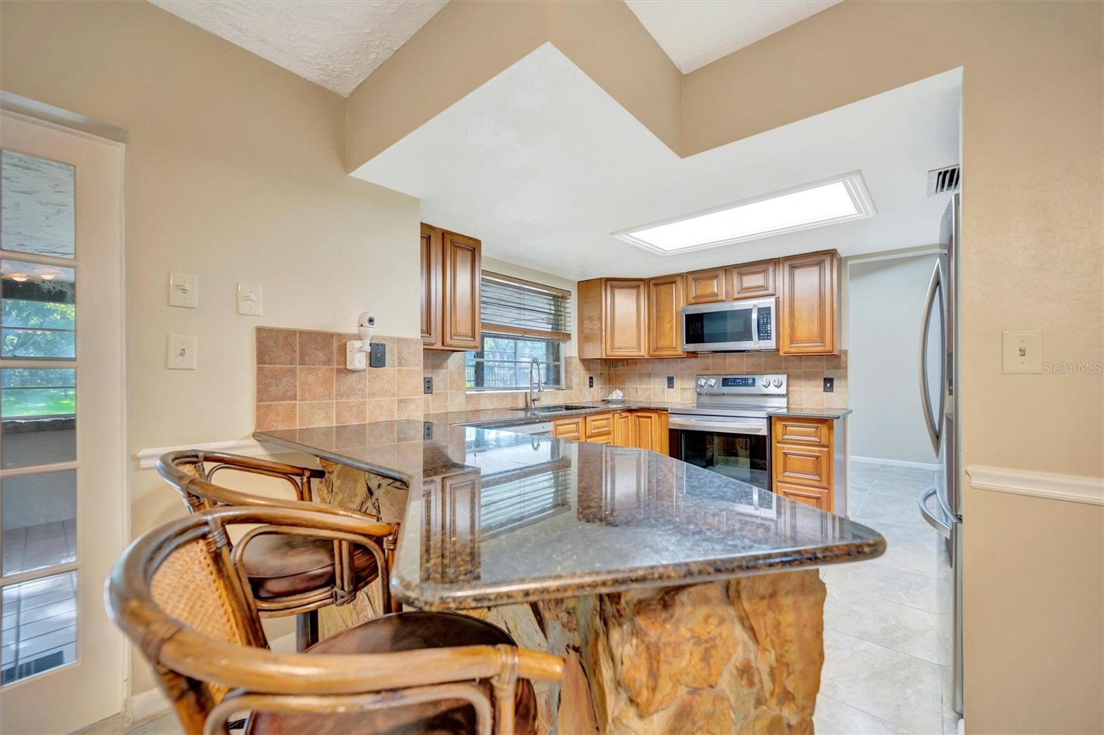 Central Kitchen with dining spaces on either side