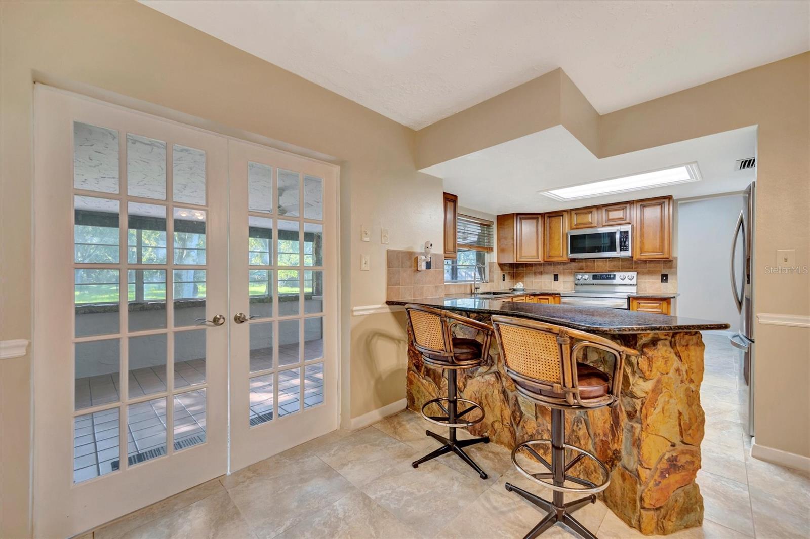 French Doors open to sunroom with bar