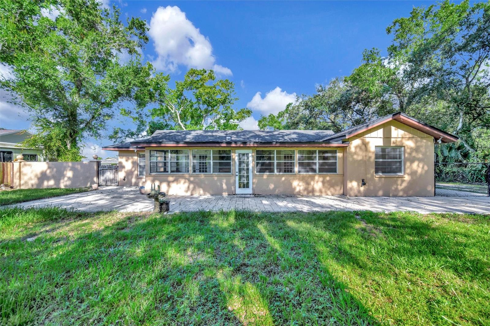 Sunroom opens to spacious paved area