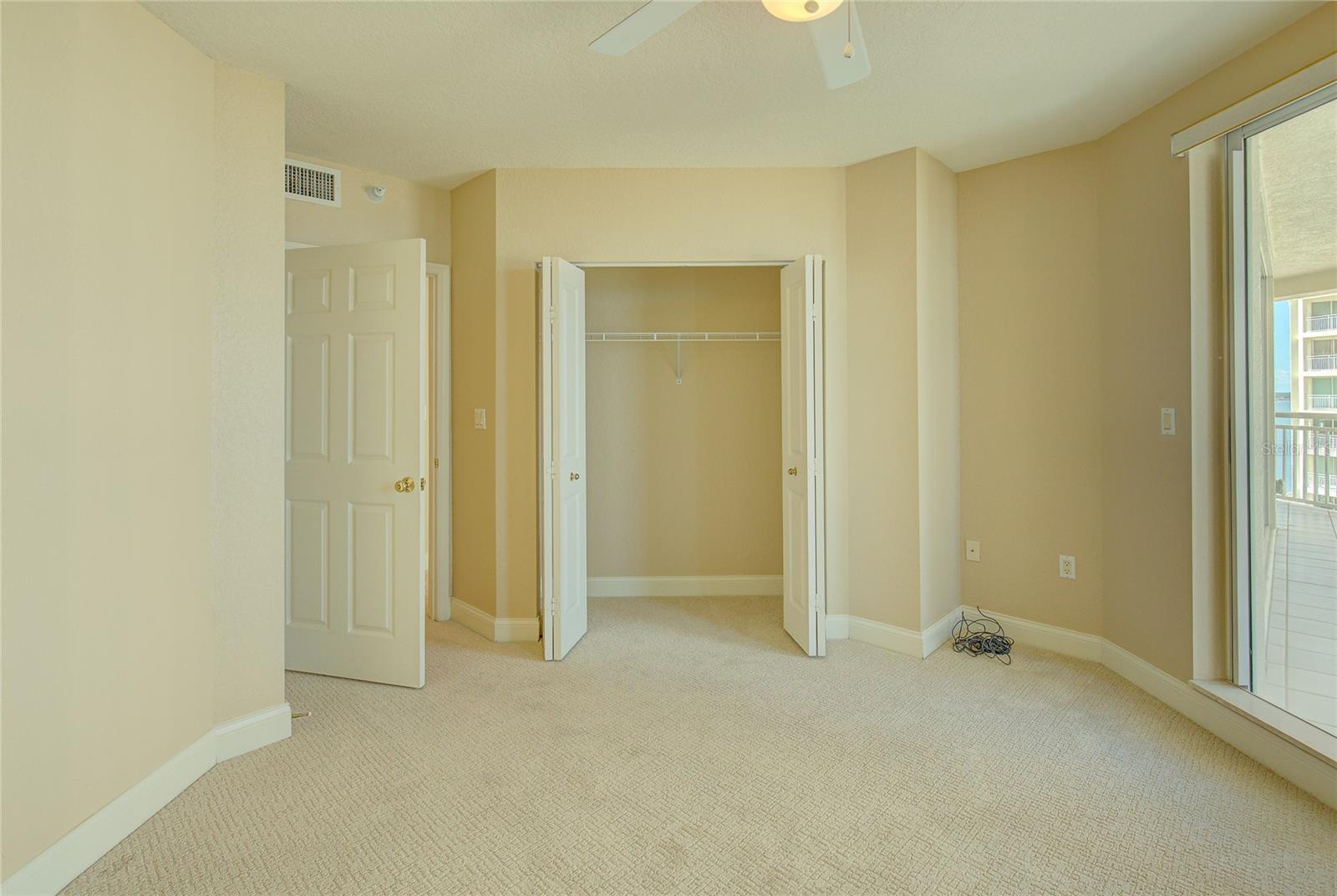 Large guest bedroom with plenty of closet space.