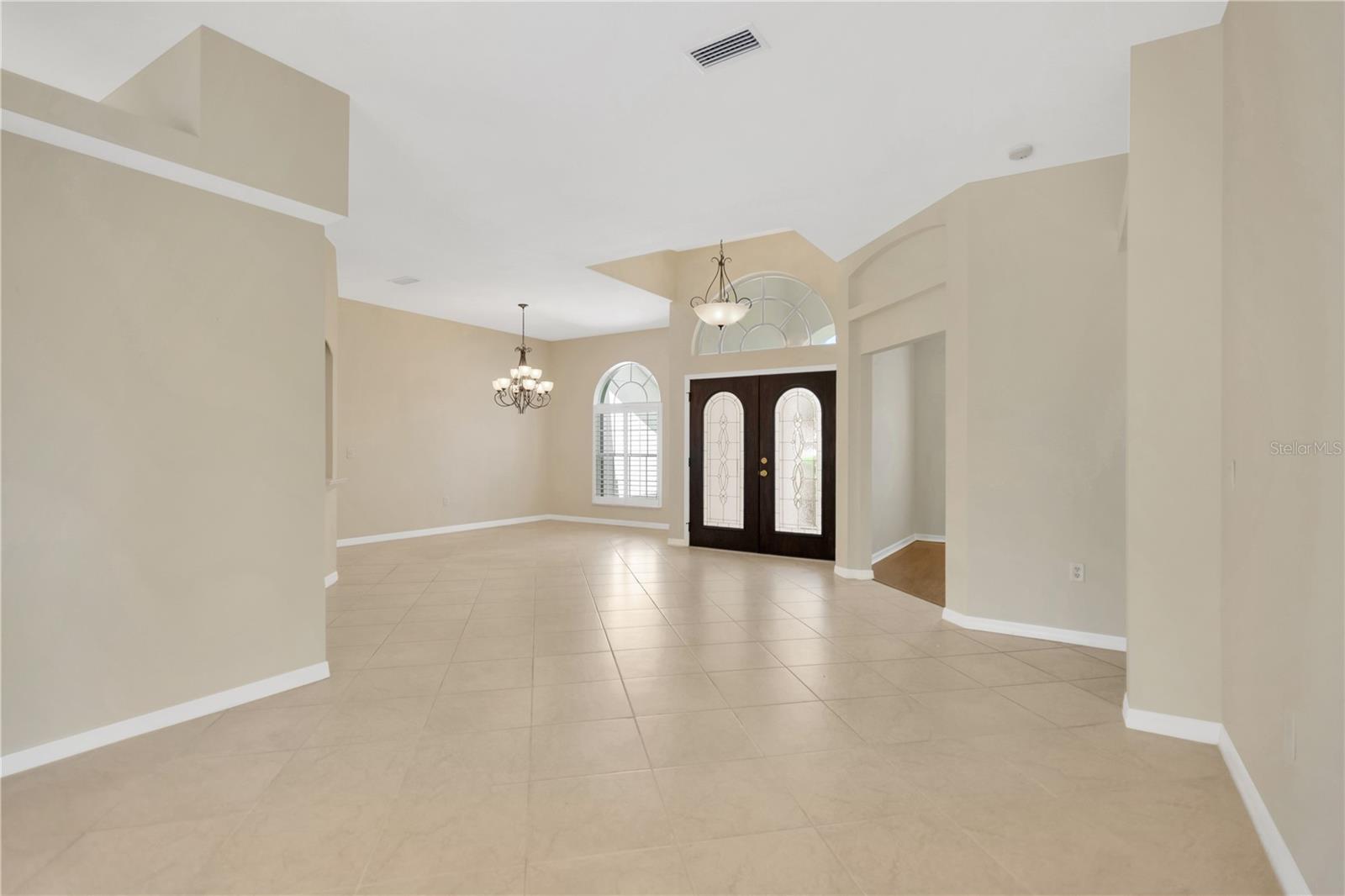 Looking at the dining room and front door from the formal living room.