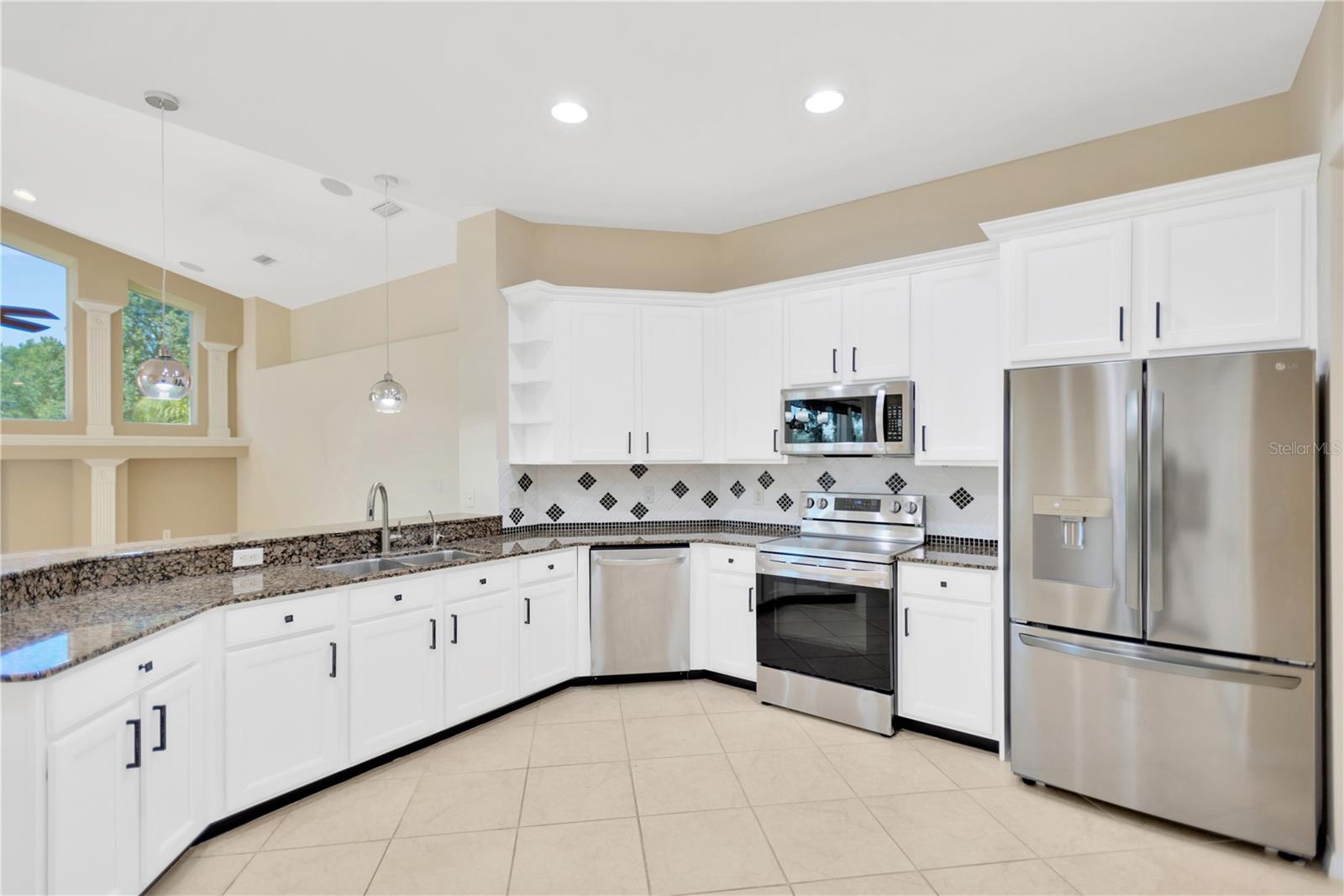 The kitchen is open to the family room and boasts granite countertops and stainless steel appliances.