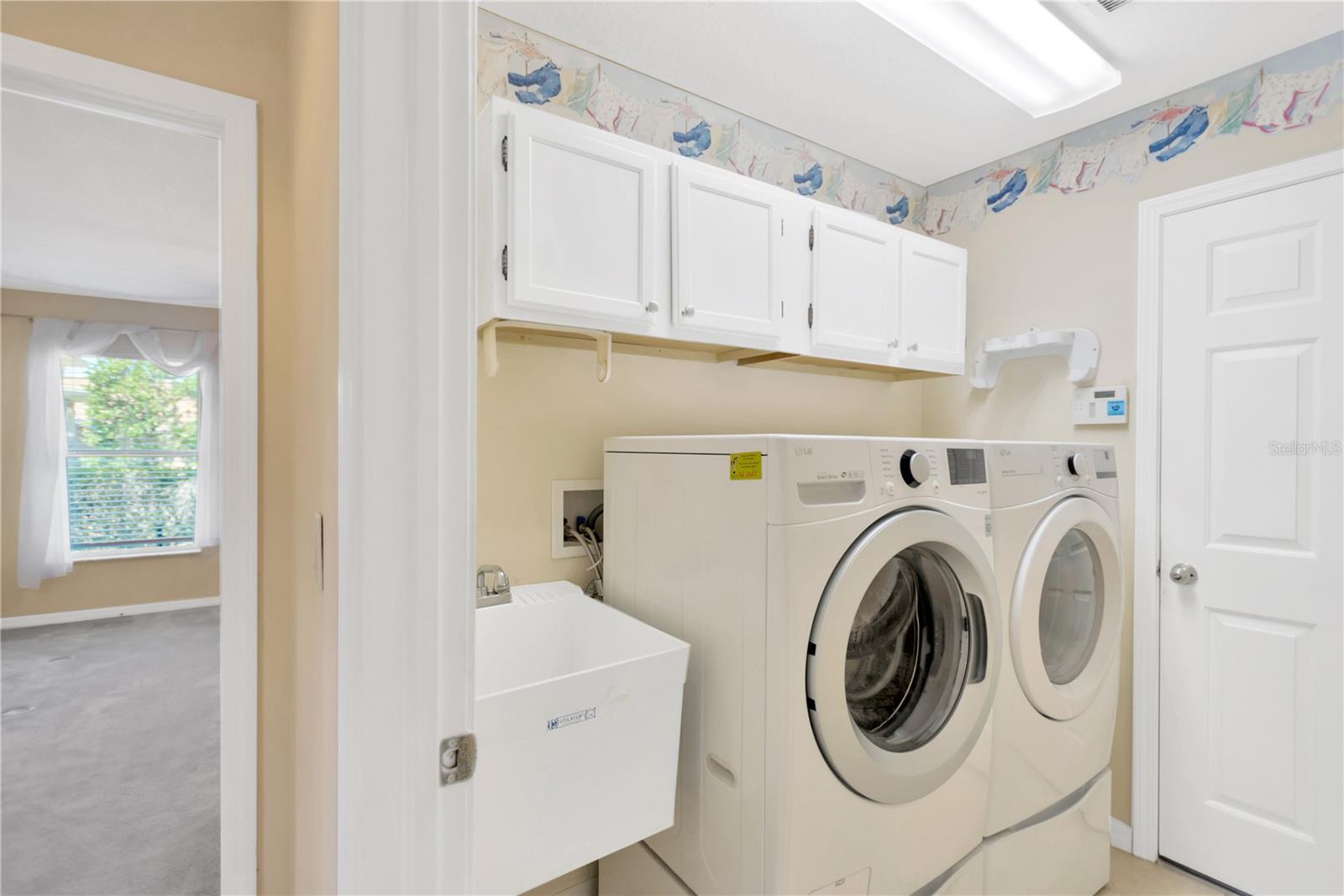 Laundry room includes the washer & dryer with a handy utility sink and cabinets for extra storage. It also gives you easy access to the 3 car garage.  It's located just across the hallway from the kitchen.
