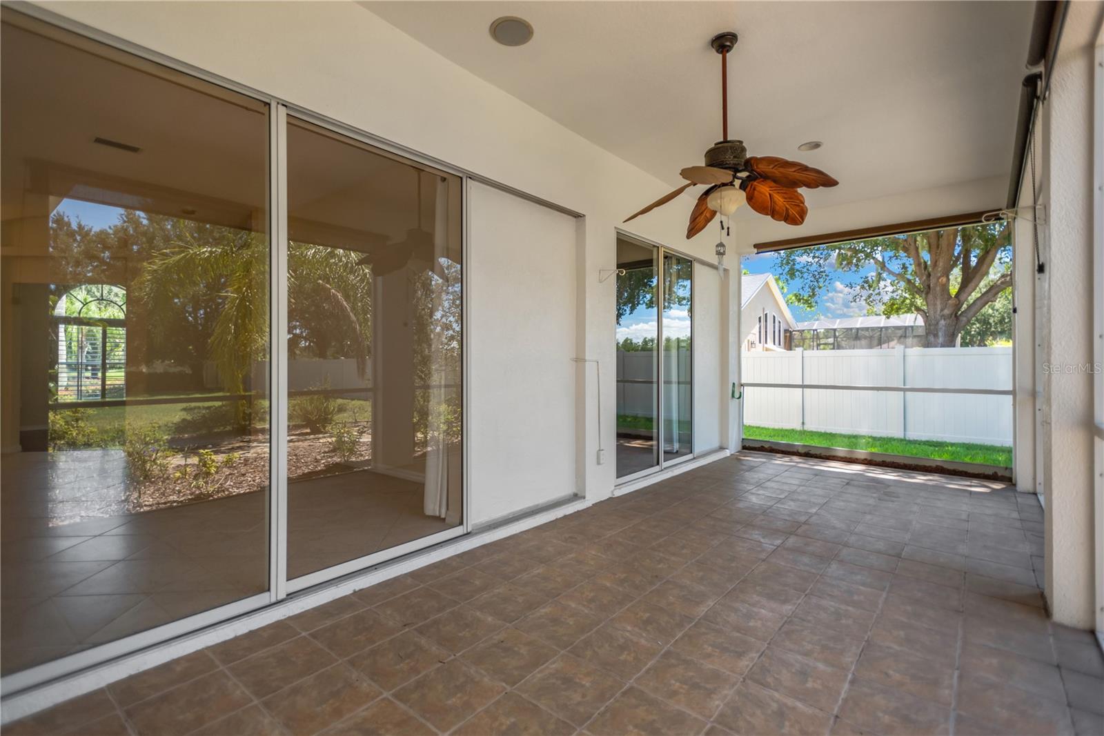 L shaped screened lanai has access from the primary bedroom, formal living room and family room.