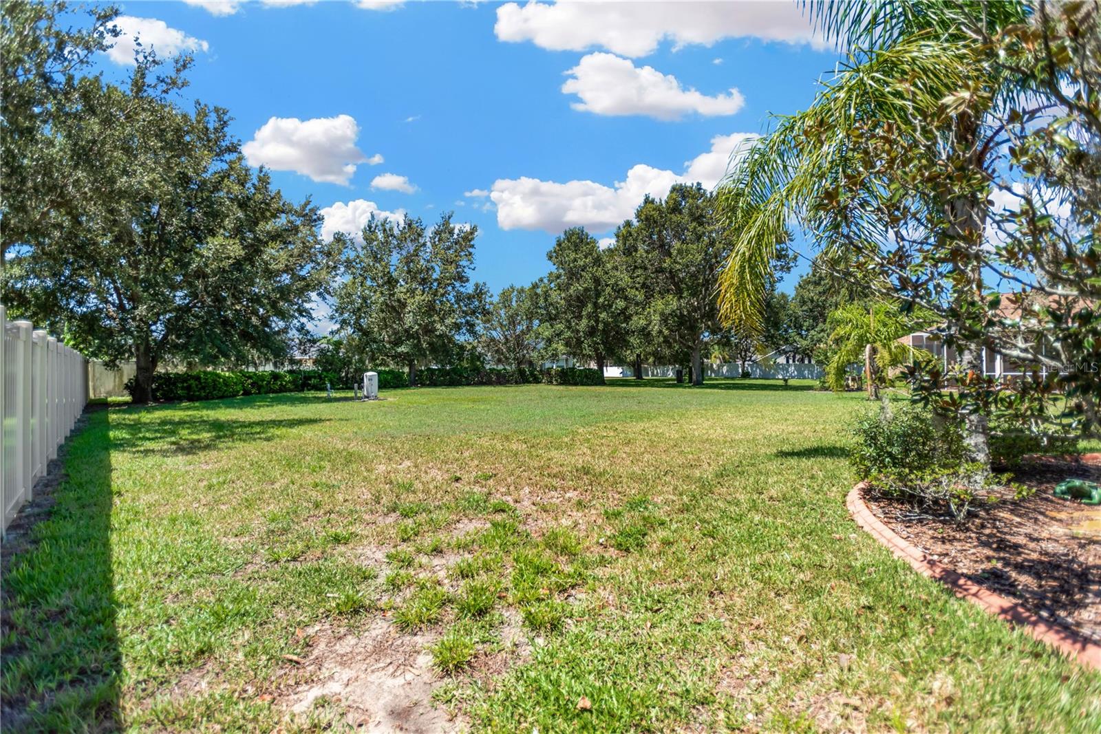 Backyard showing one side is fenced and the well.