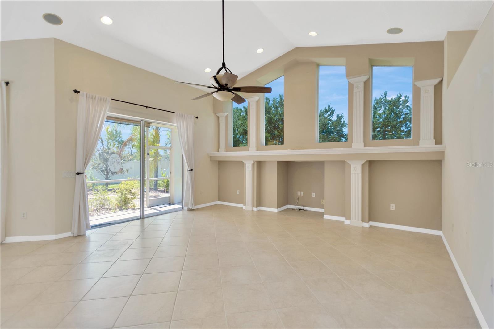 The family room is open to the kitchen and the large windows and sliders let in wonderful natural light.