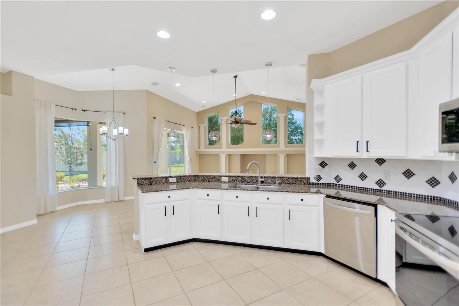 Open great room showing kitchen breakfast nook and family room.