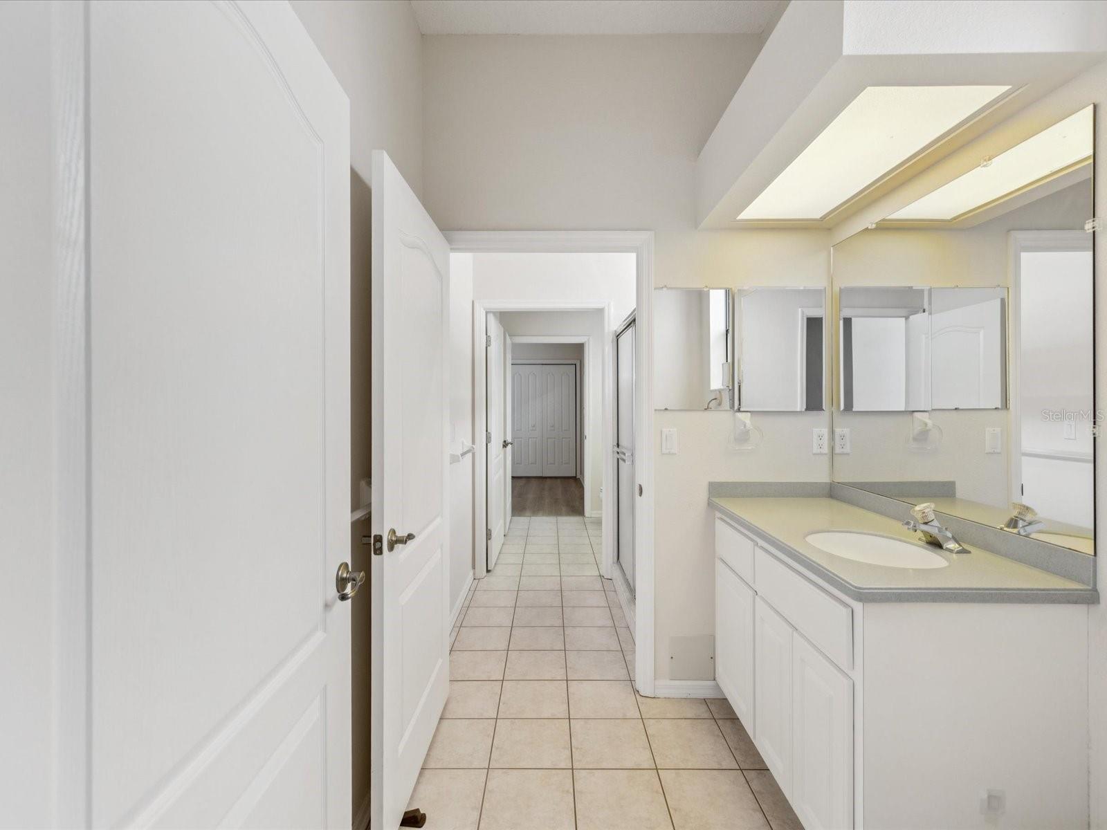 jack/Jill bathroom with tub/shower connected to separates sink and commodes