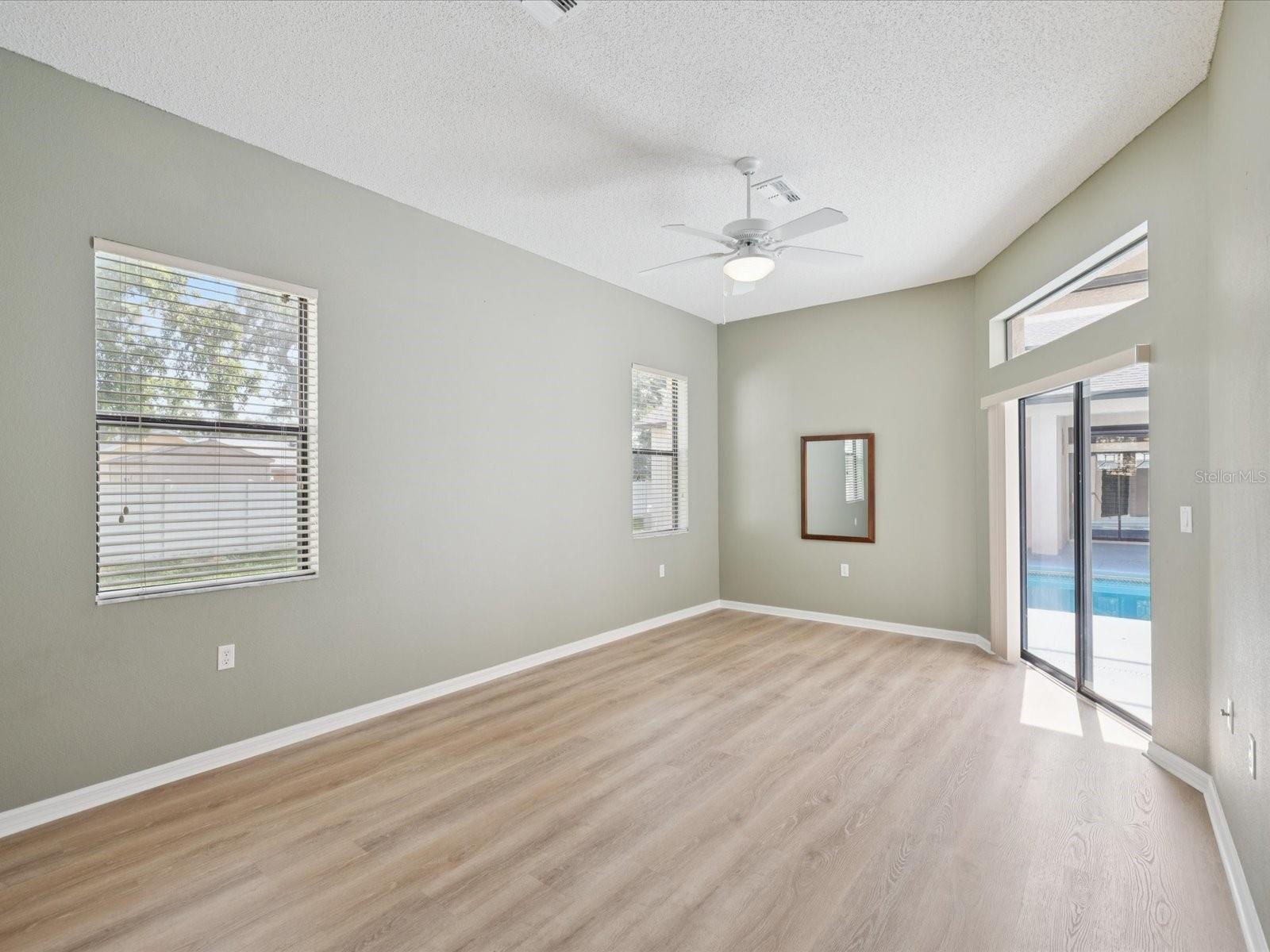 primary bedroom 3 in law side with walk in closet and sliding doors to pool