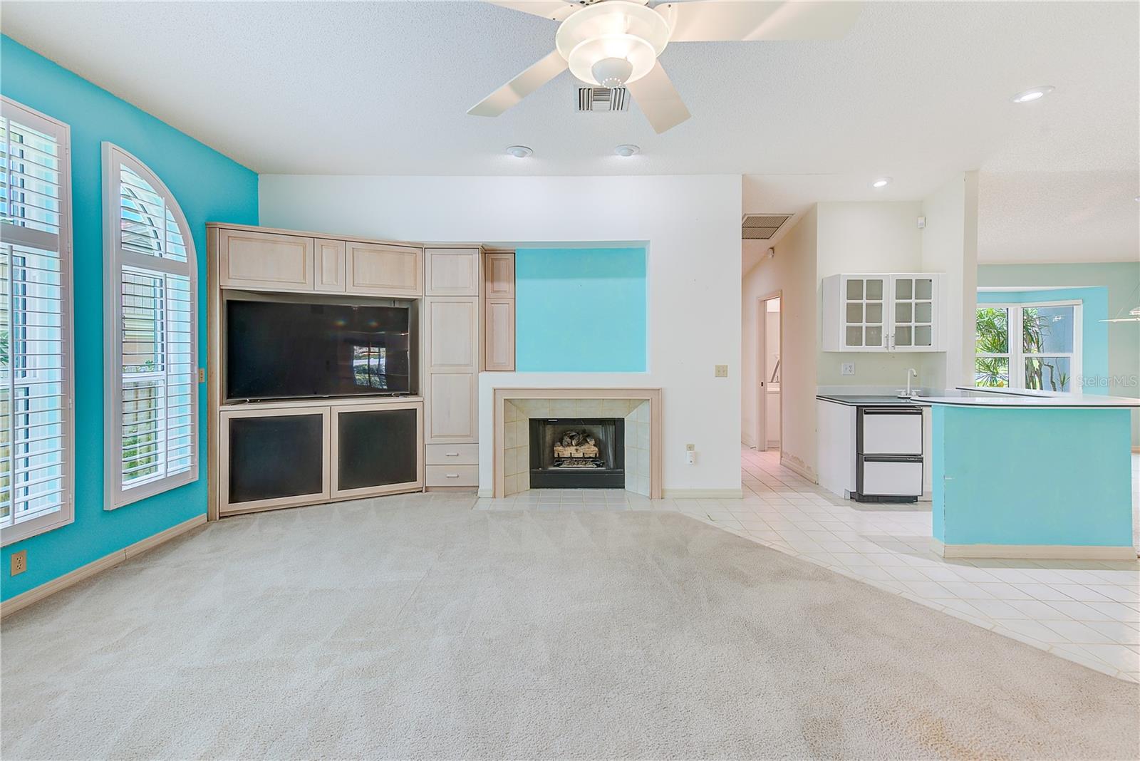 Family room with gas fireplace - all new hurricane-impact windows and doors throughout