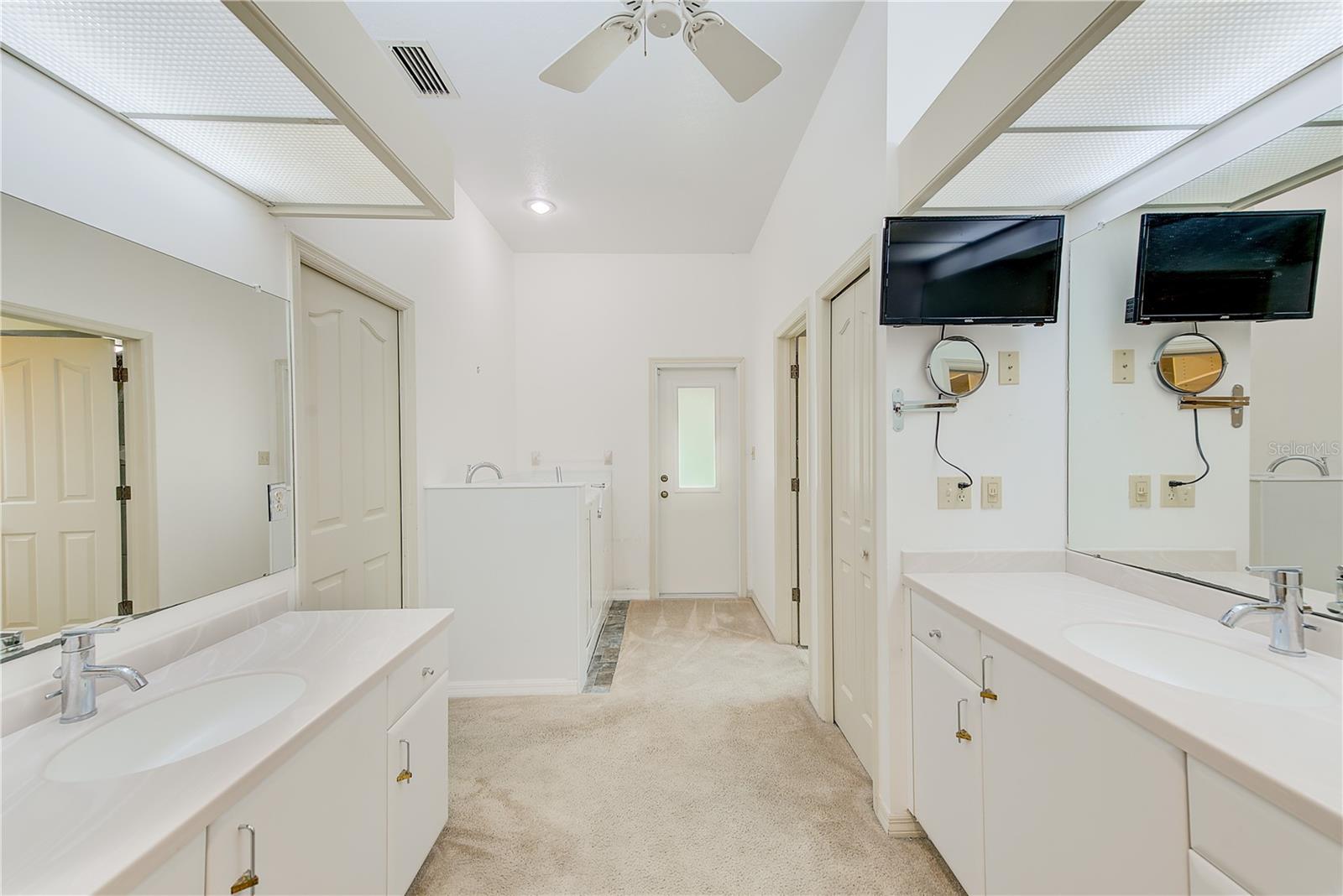 Primary bathroom with walk-in tub and access to the pool