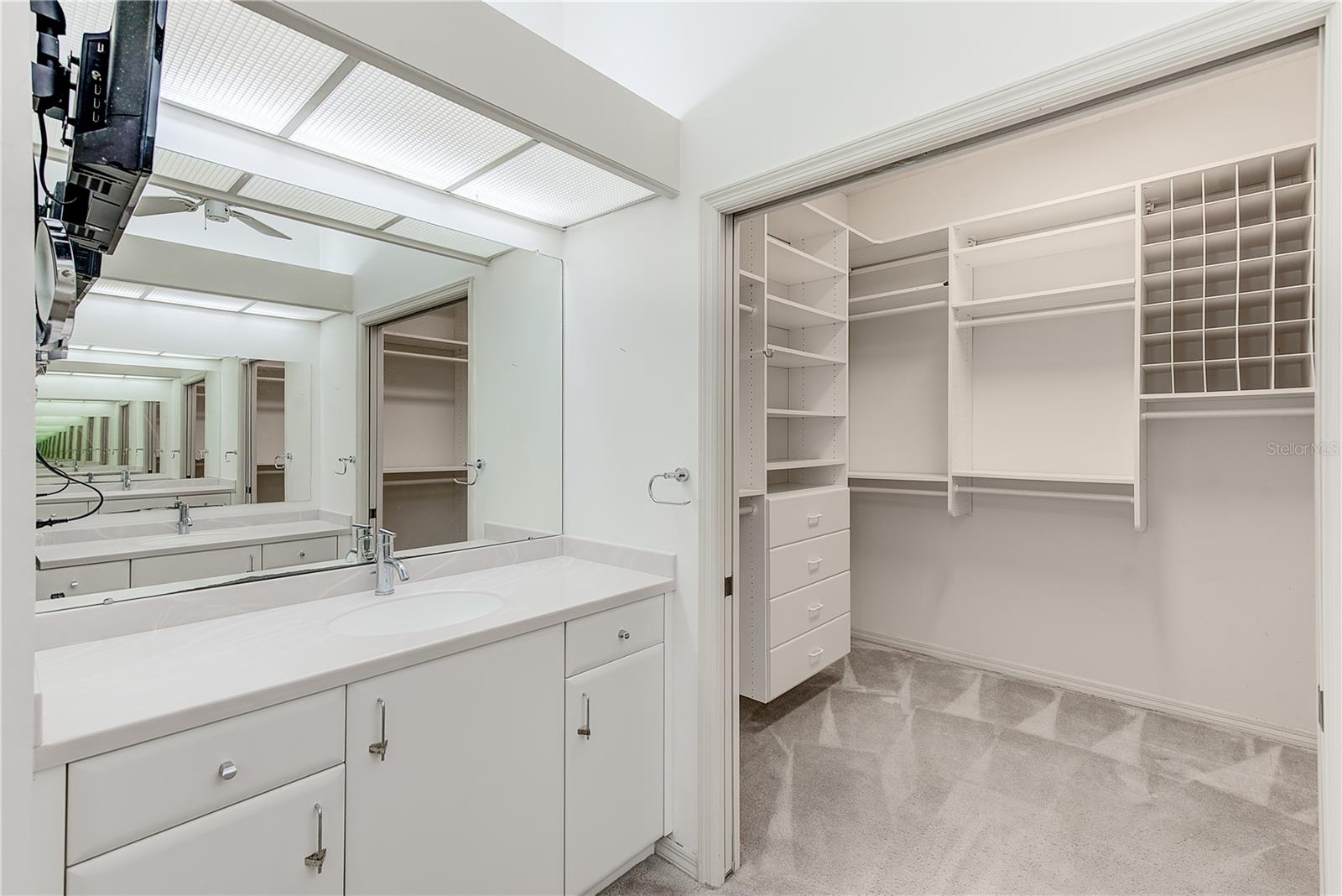 Primary bathroom with sliding doors into walk-in closet