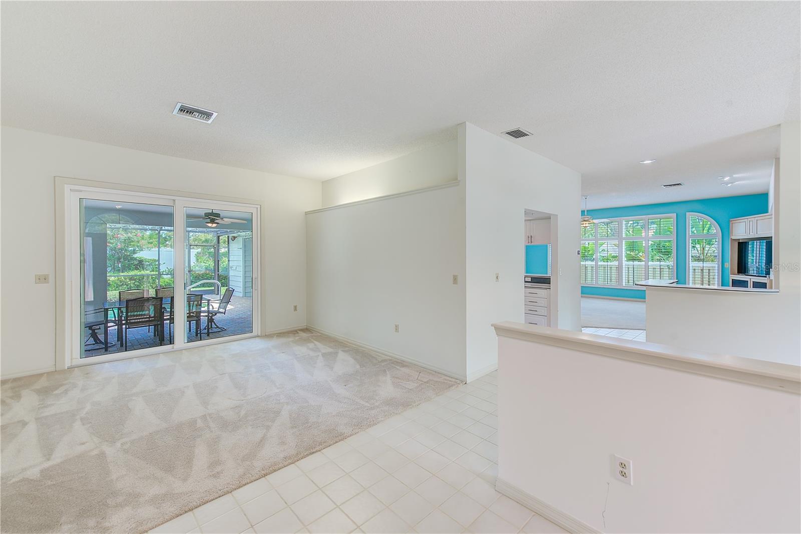 Formal living room with access to the lanai and pool