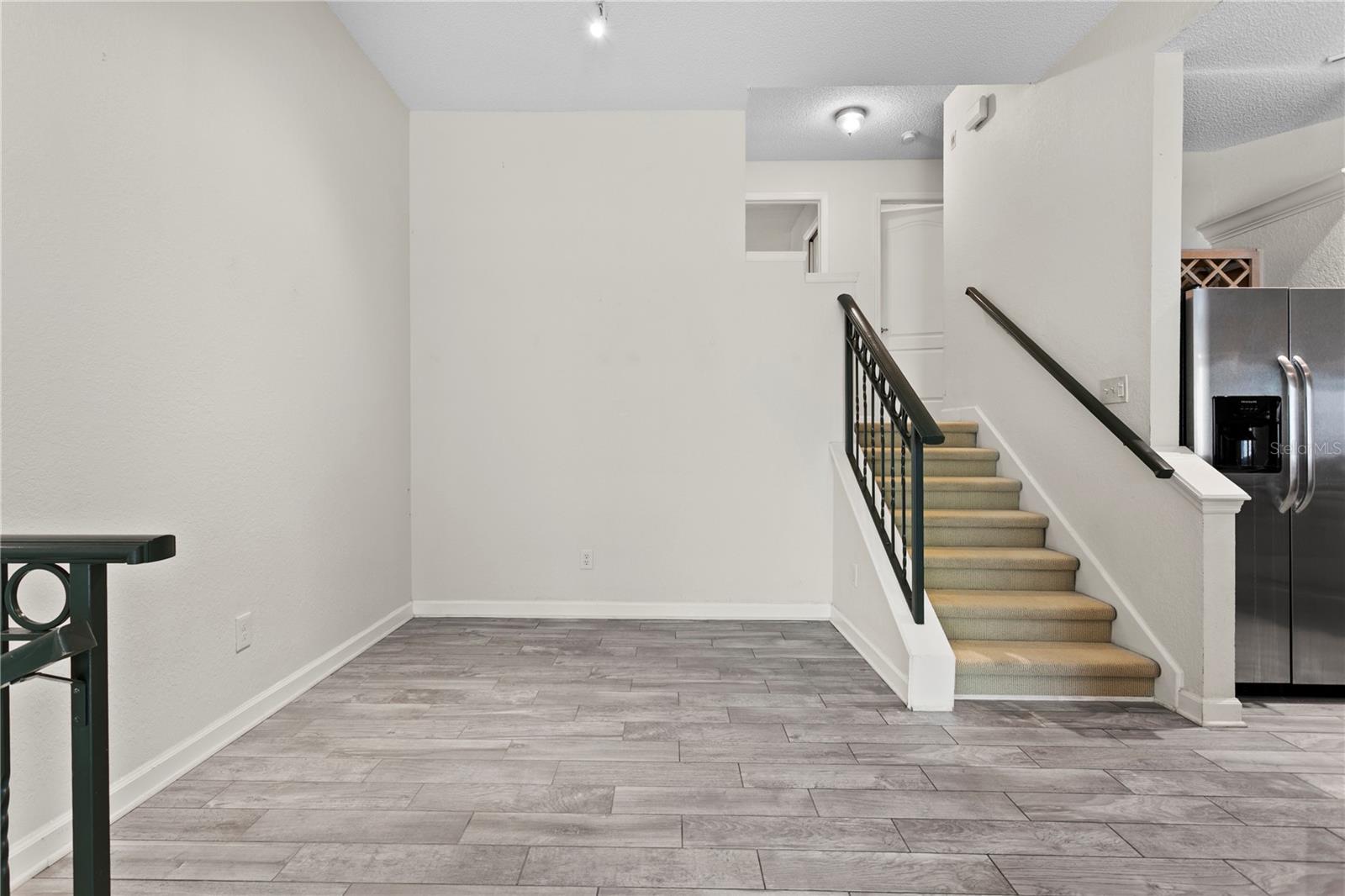 Up just a half flight of stairs, you'll find the private quarters — including the bedroom, a full bathroom, and convenient laundry space.