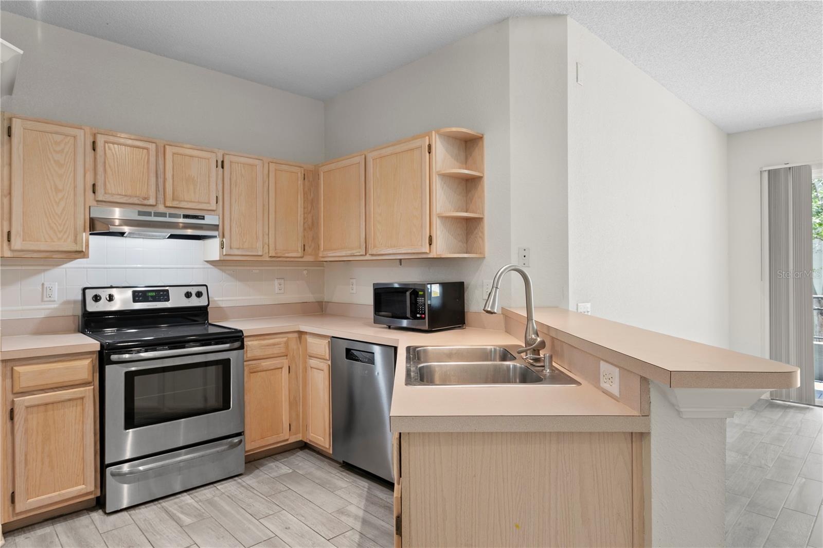 With generous counters and room for barstools, guests can pull up a seat and enjoy the action in the kitchen.