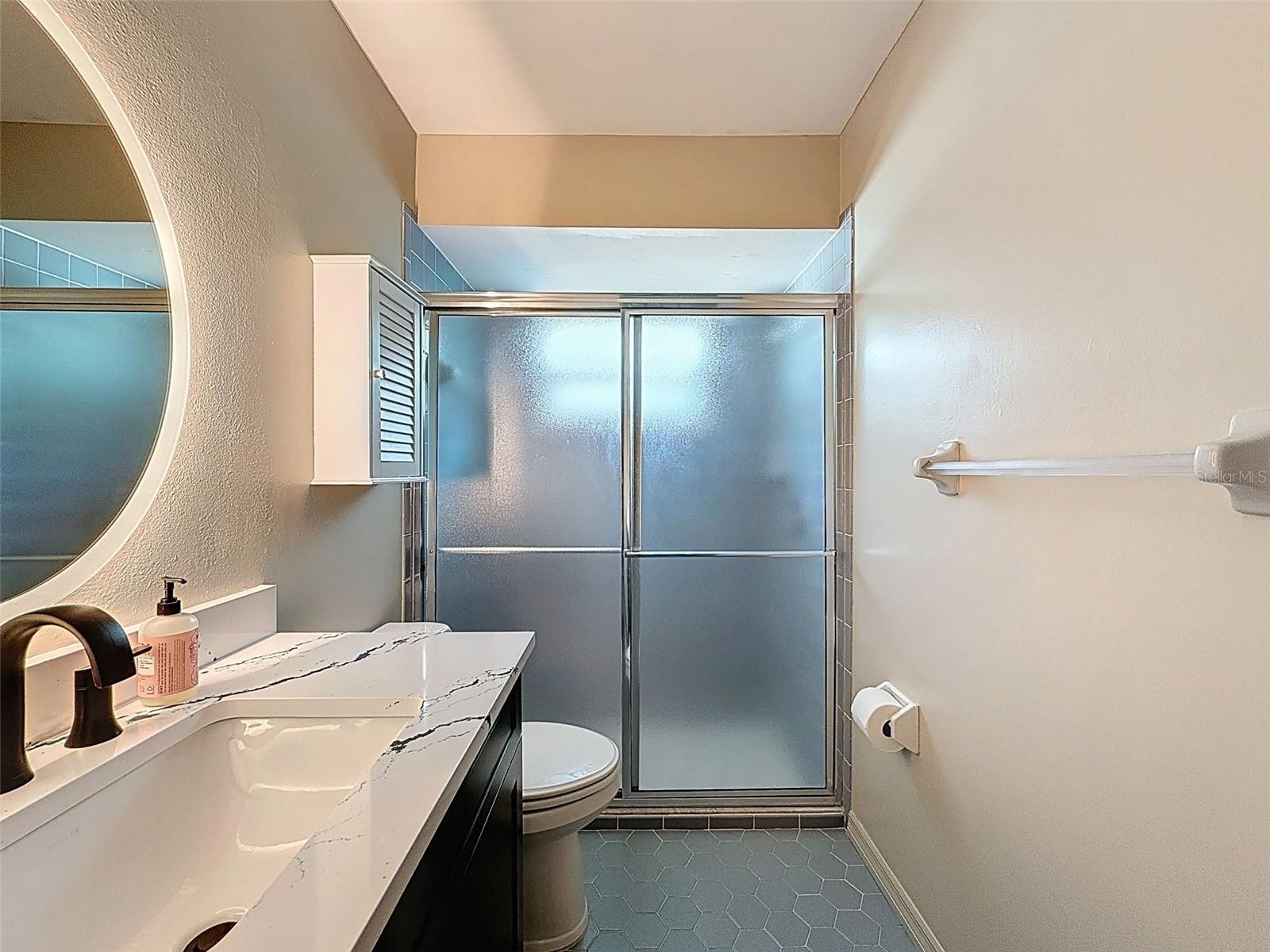 SECOND bedroom's en-suite bathroom with closet.