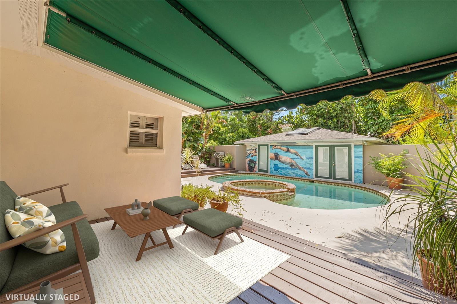 Virtually staged rear porch overlooking the pool, spa and guesthouse.
