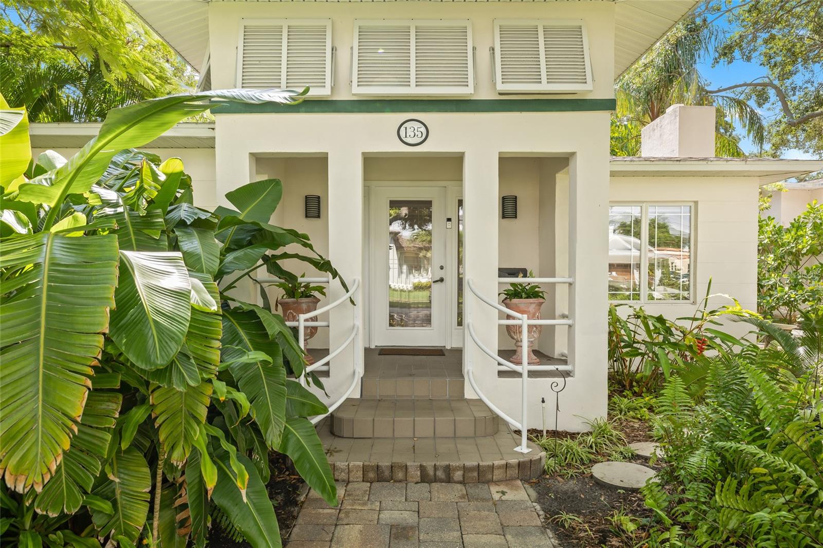 Lush and landscaped approach to the front entrance.