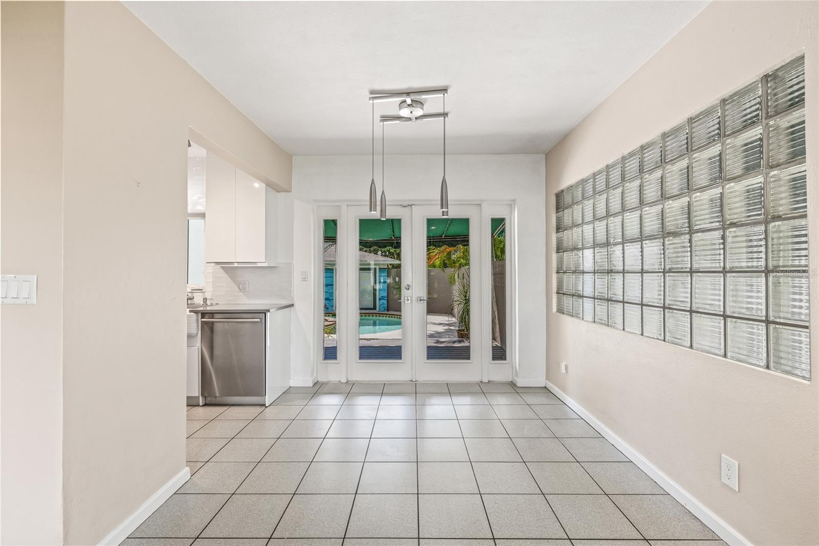 Spacious dining adjacent to the kitchen and rear porch for poolside dining - even while inside.