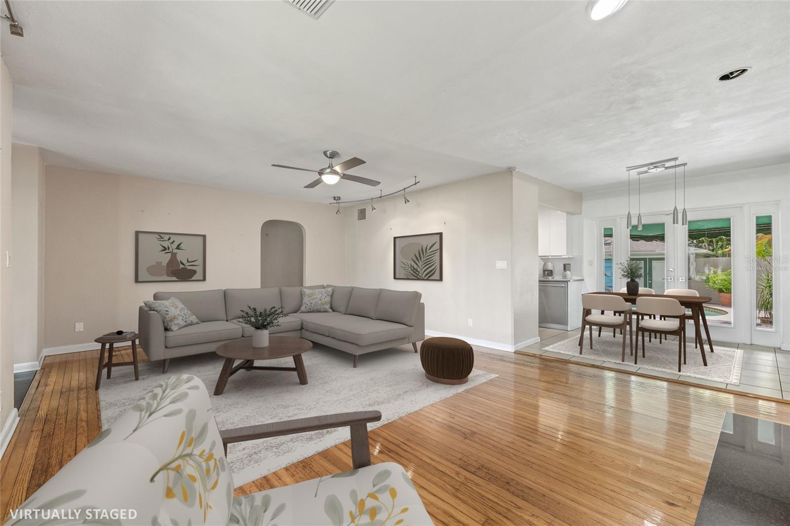 Virtually Staged. Gorgeous natural light with the front windows and French doors to the pool oasis.