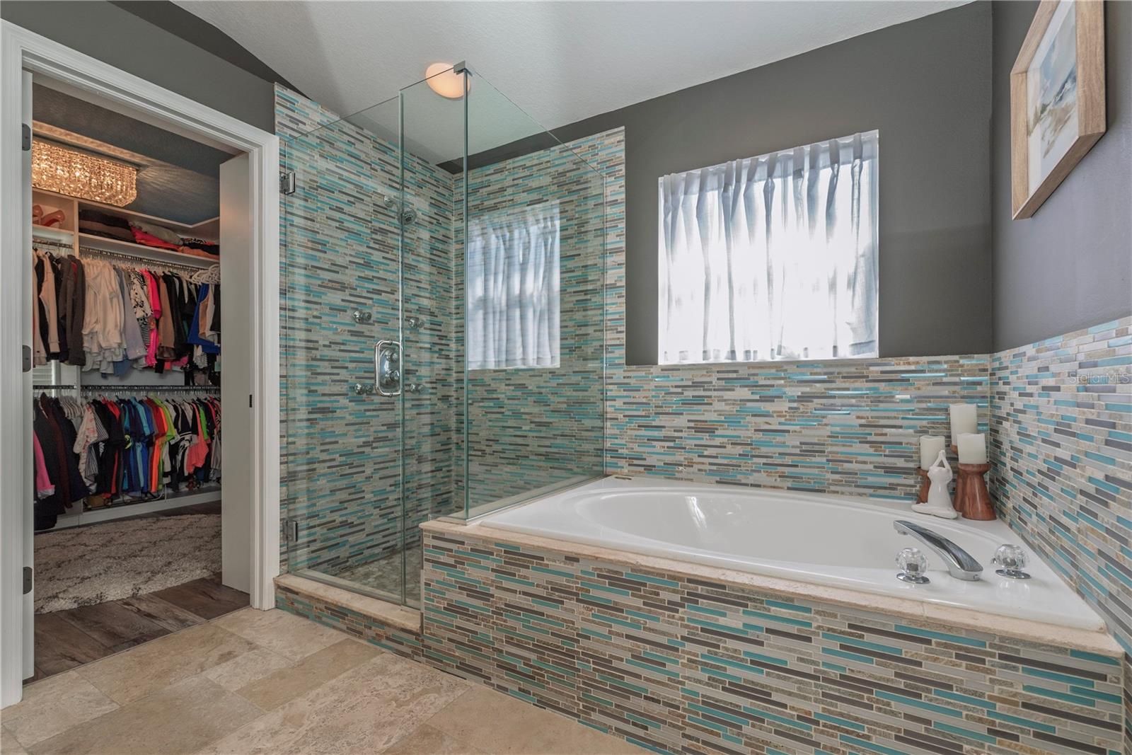 Primary bathroom garden tub and separate shower stall.