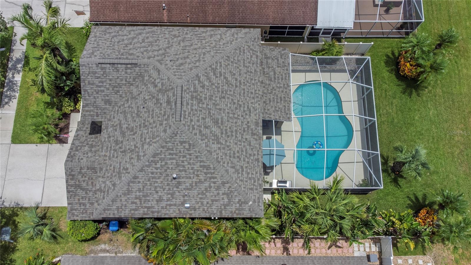 Aerial view of home, new roof, and pool.