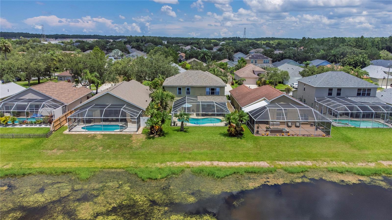 Aerial view of home with pond.