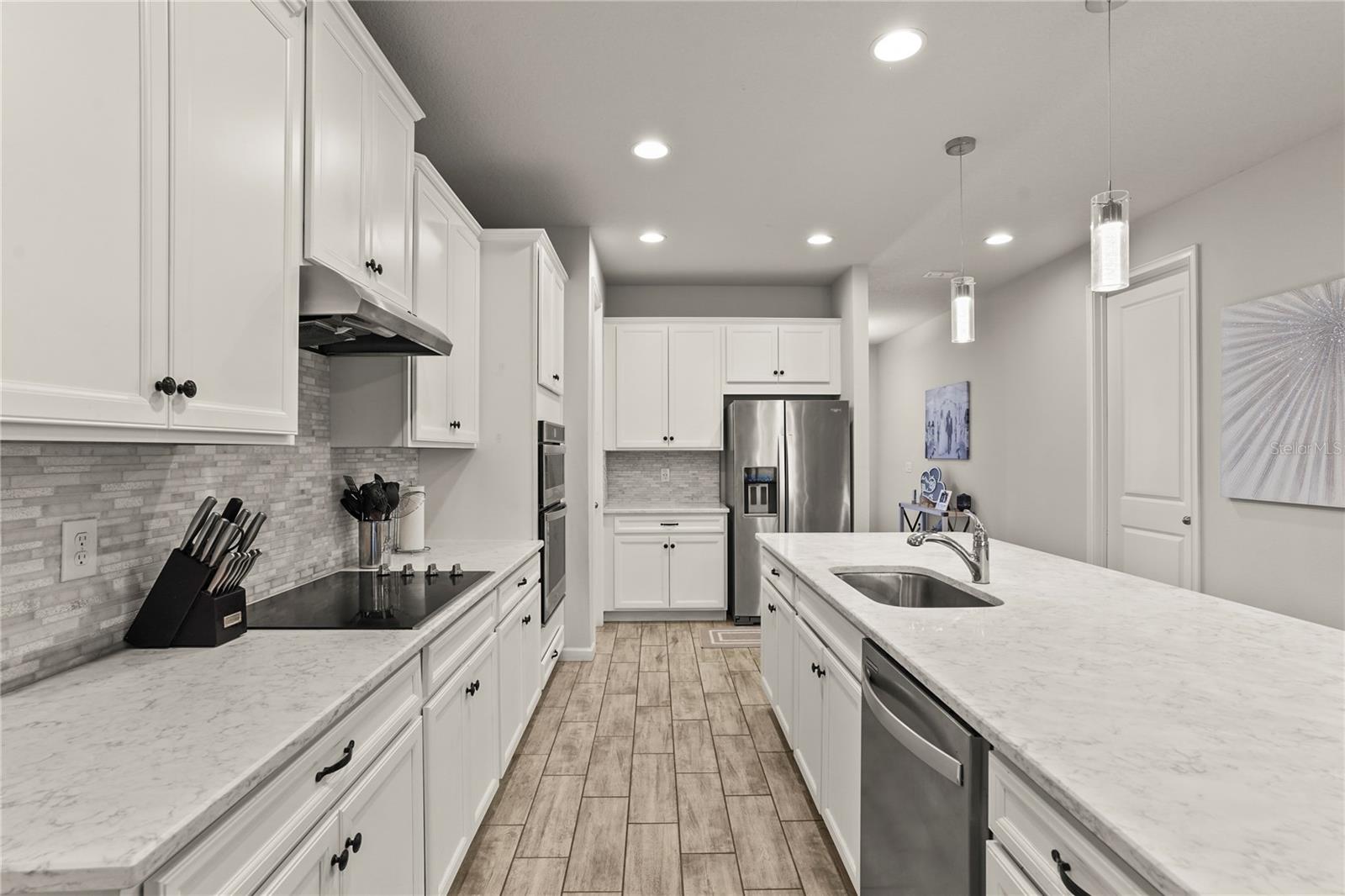 Kitchen view facing microwave and oven
