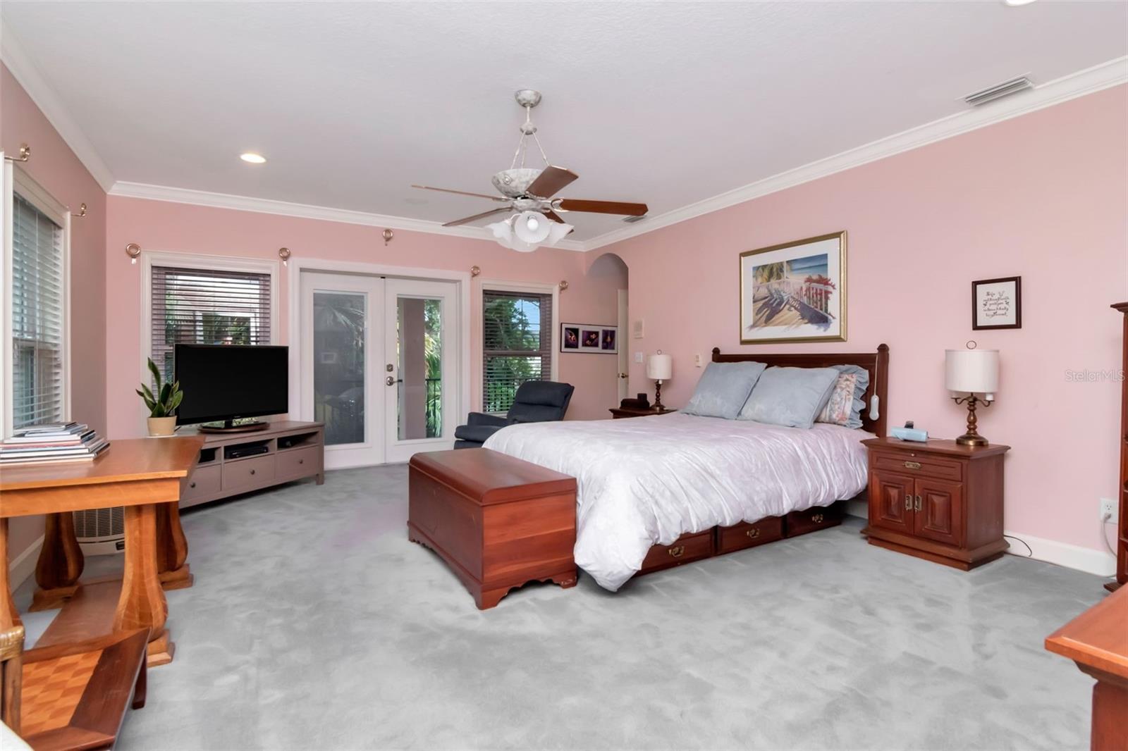Spacious primary suites with high ceilings, crown moldings, and access to a large balconcy - all overlooking park like rear yard.