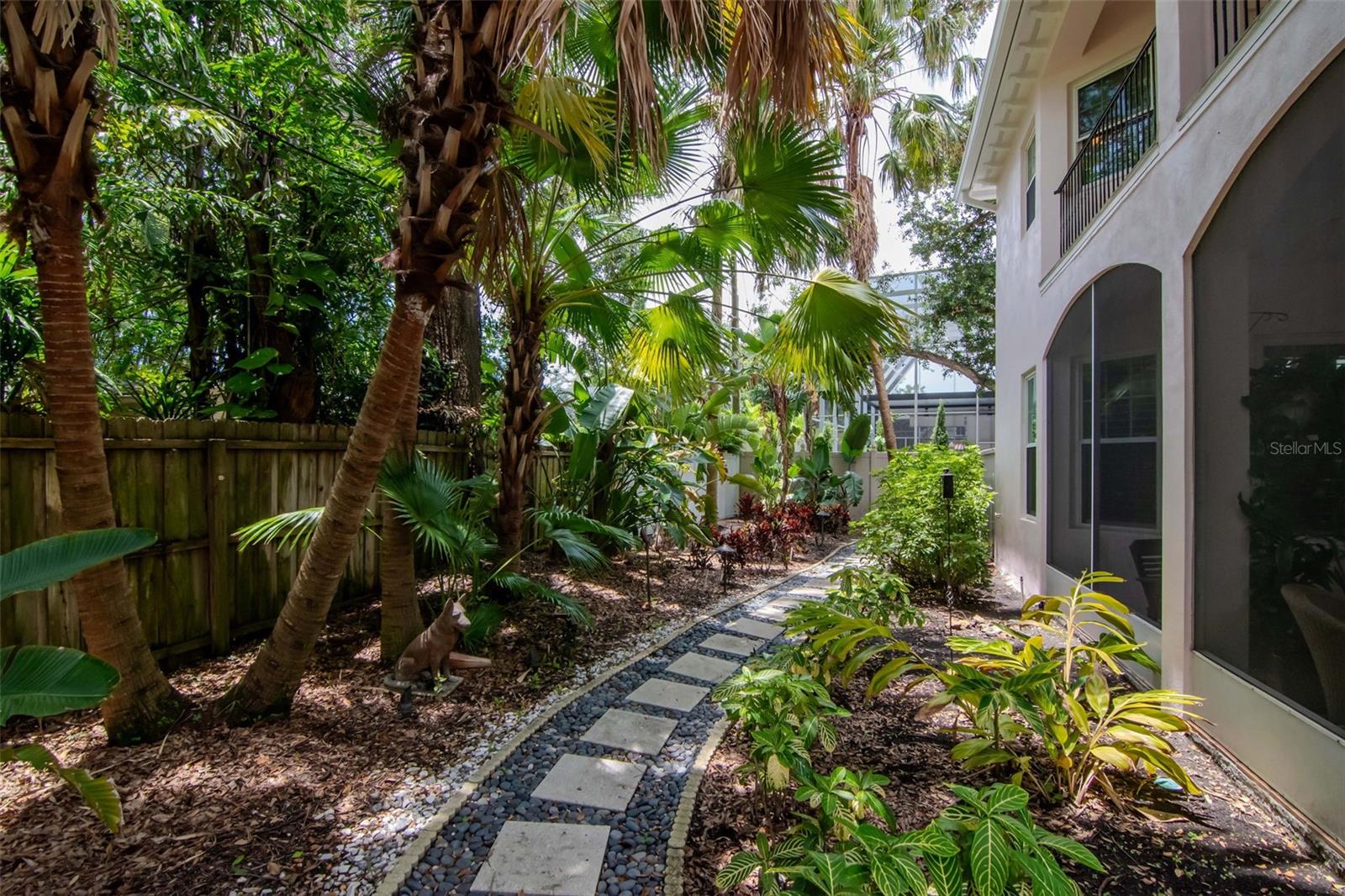 Screen porch and balcony on rear of home enjoy a bird's eye view of the rear yard.
