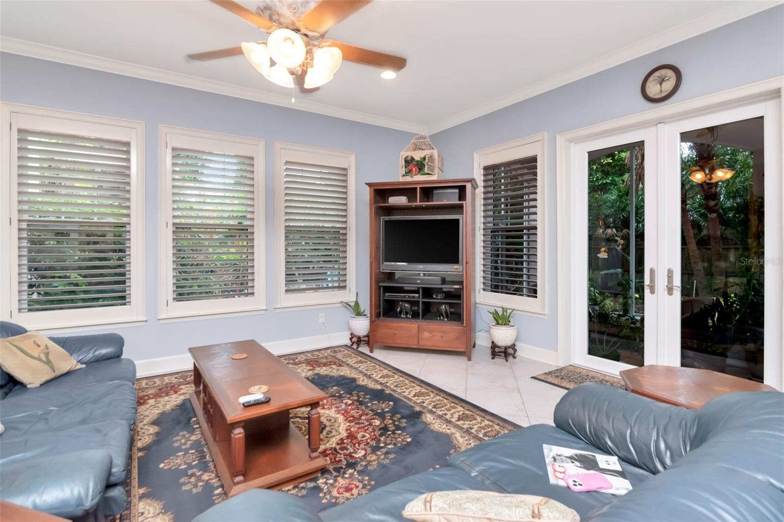 Family room enjoys natural light and windows overlooking rear yard & french doors accessing screened porch.