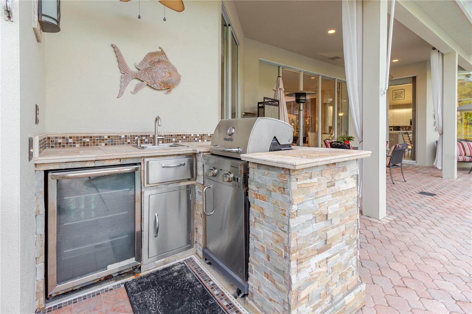 Outdoor Kitchen with grill, fridge, sink with new faucet