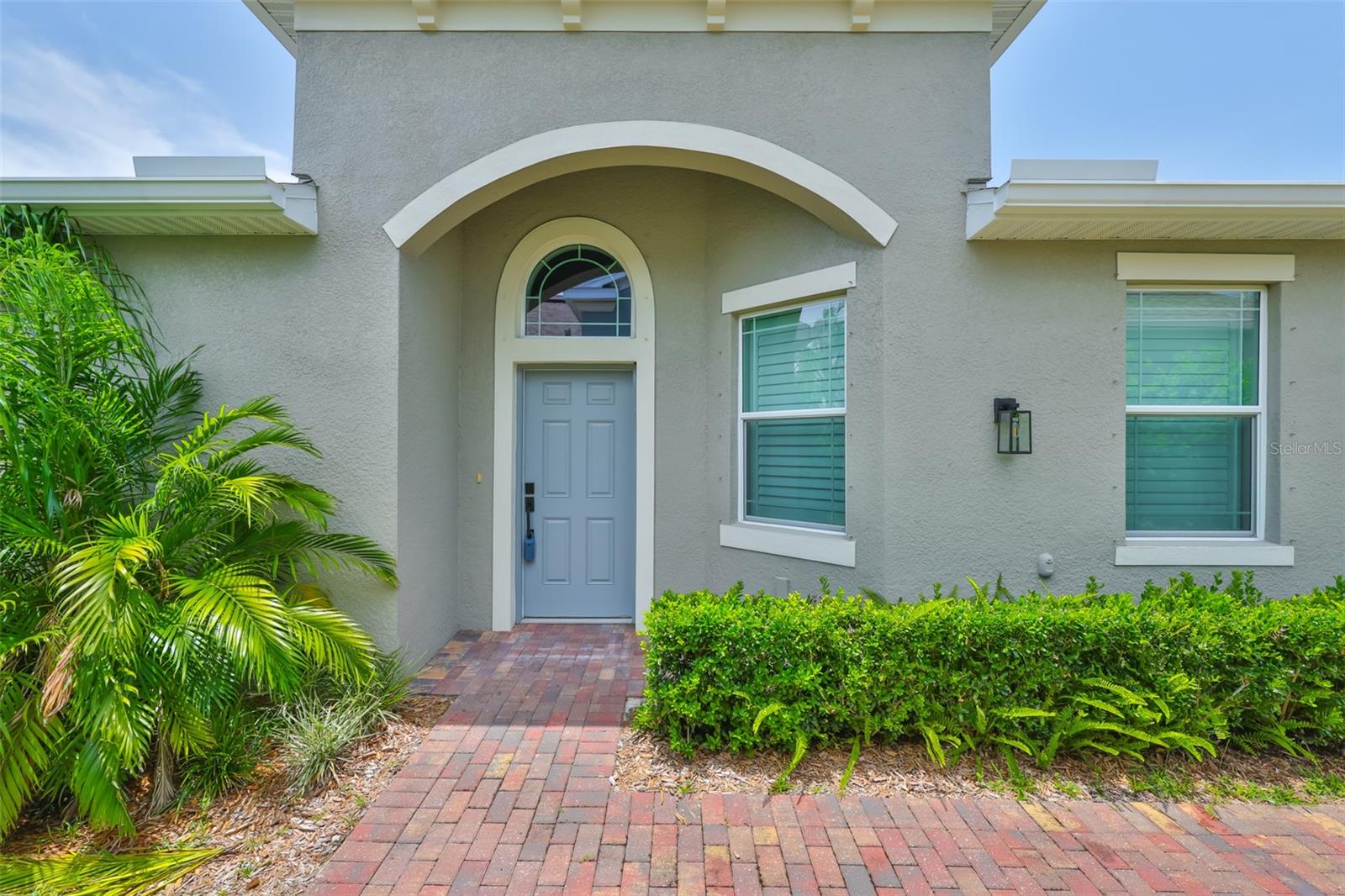 Custom brick pavered sidewalk welcomes all guests to the front door.