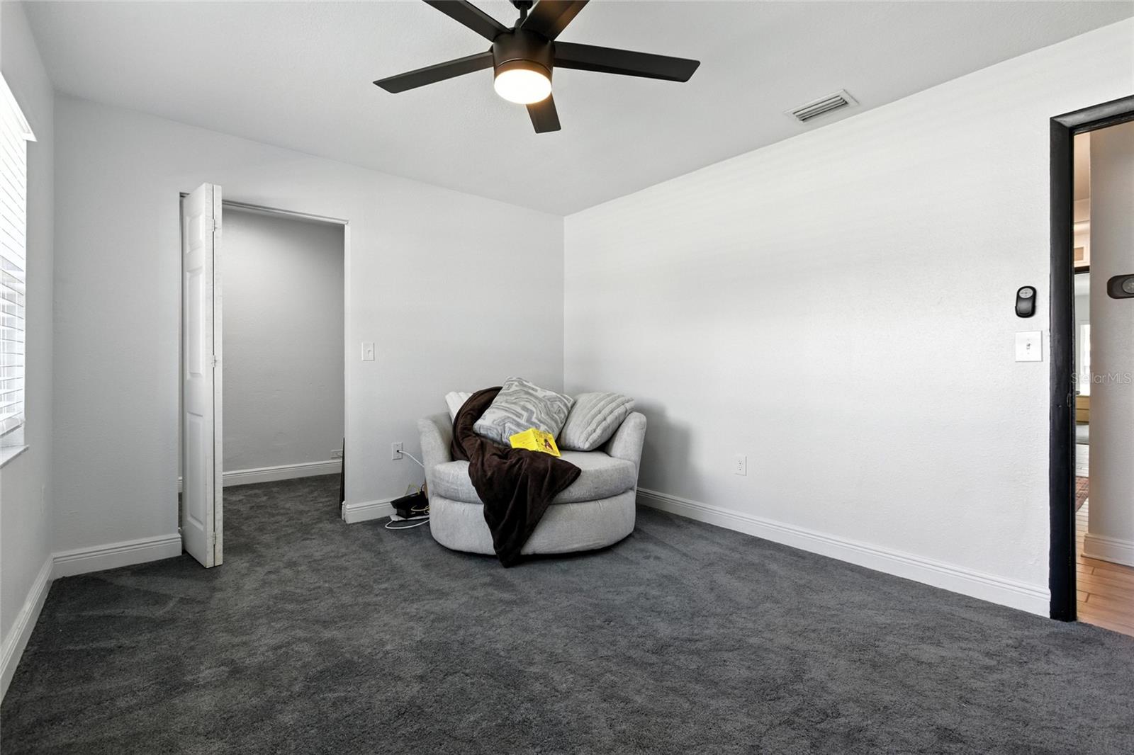 The front bedroom offers generous natural light, a spacious layout, and an oversized walk-in closet ready for your custom storage vision