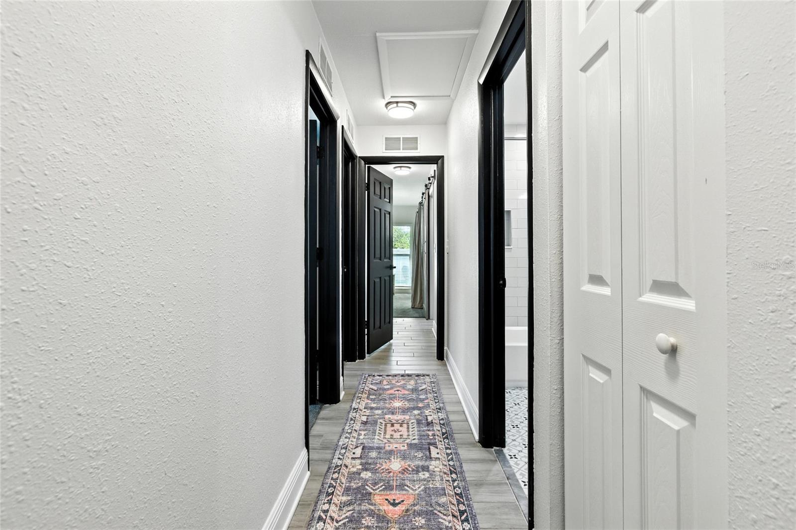 All bedrooms and the guest bath are off this central hallway, complete with wood-like tile.