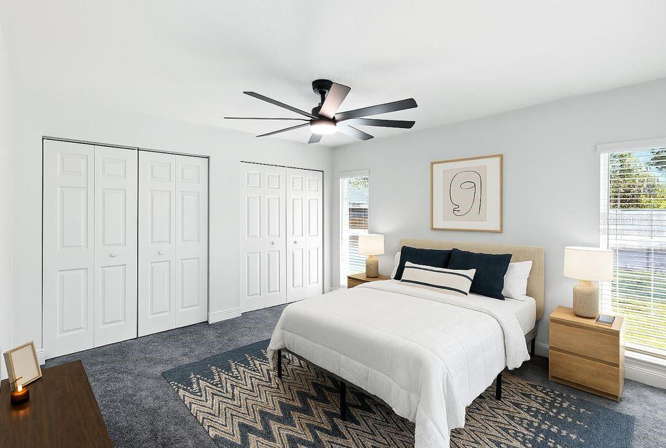 Virtually Staged -Tucked at the back of the home for added privacy, the primary suite is spacious and bright with double closets, direct access to the patio and backyard, and a private ensuite bath