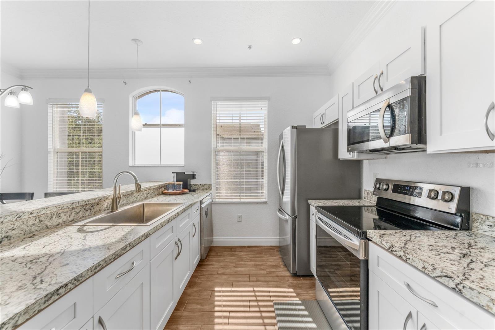 High ceilings and fully equipped kitchen with new cabinets, dishes, & cookware-all that is needed
