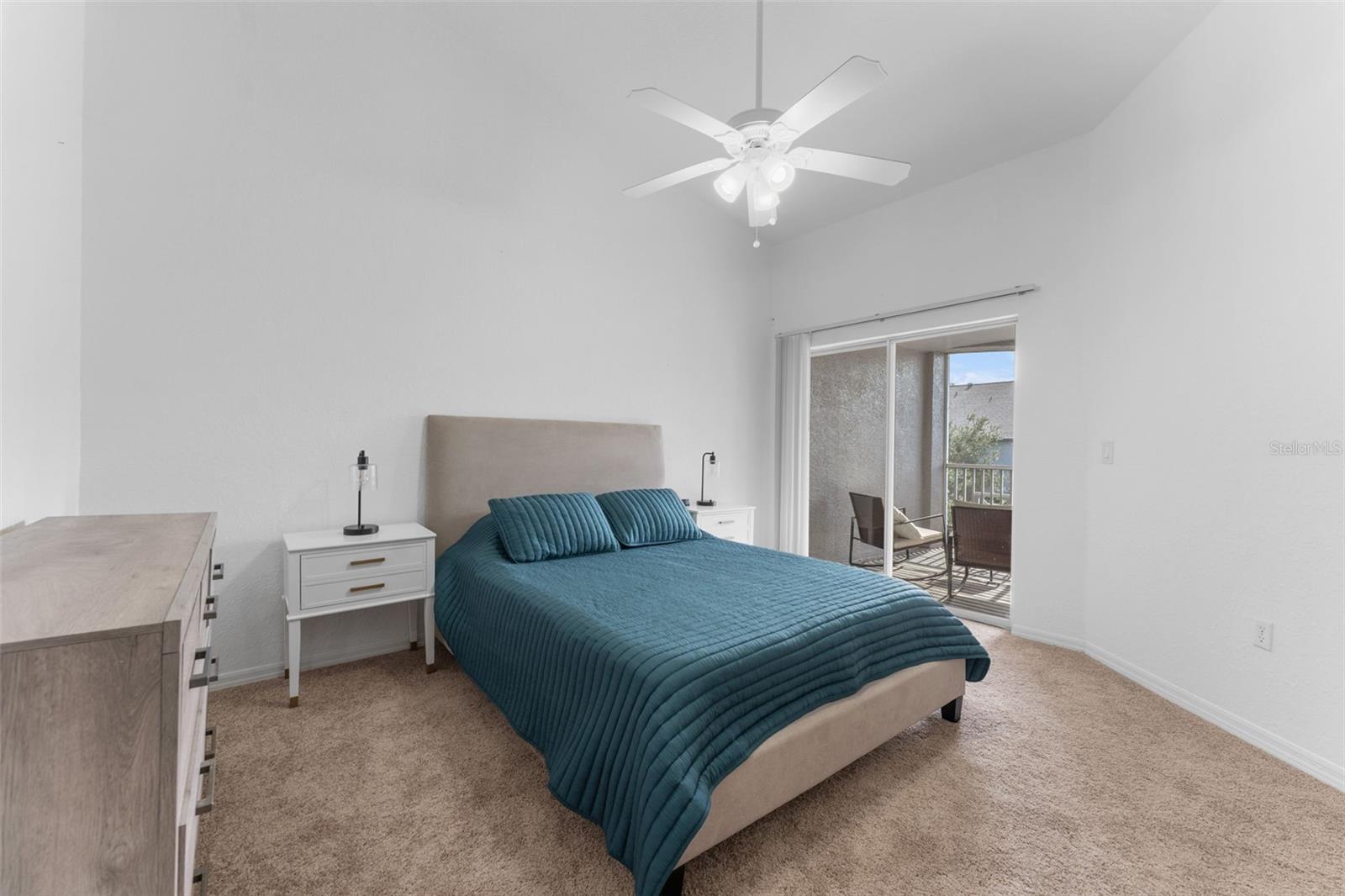 Primary bedroom with sliding doors to screened porch; fully furnished including linens