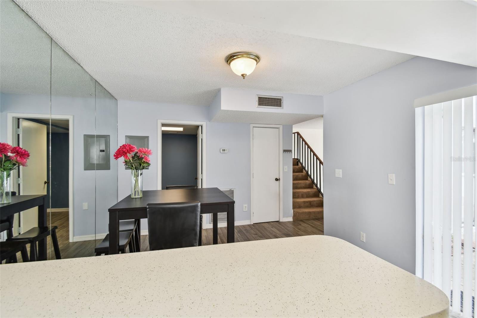 view of dining room from kitchen. Door to left is to half bath and laundry room.