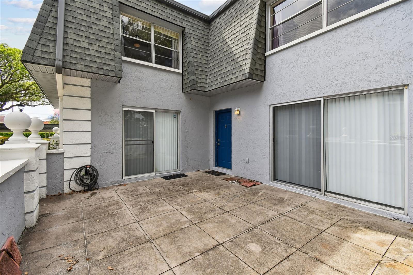 Large walled-in patio. Note the two sets of sliding glass doors.