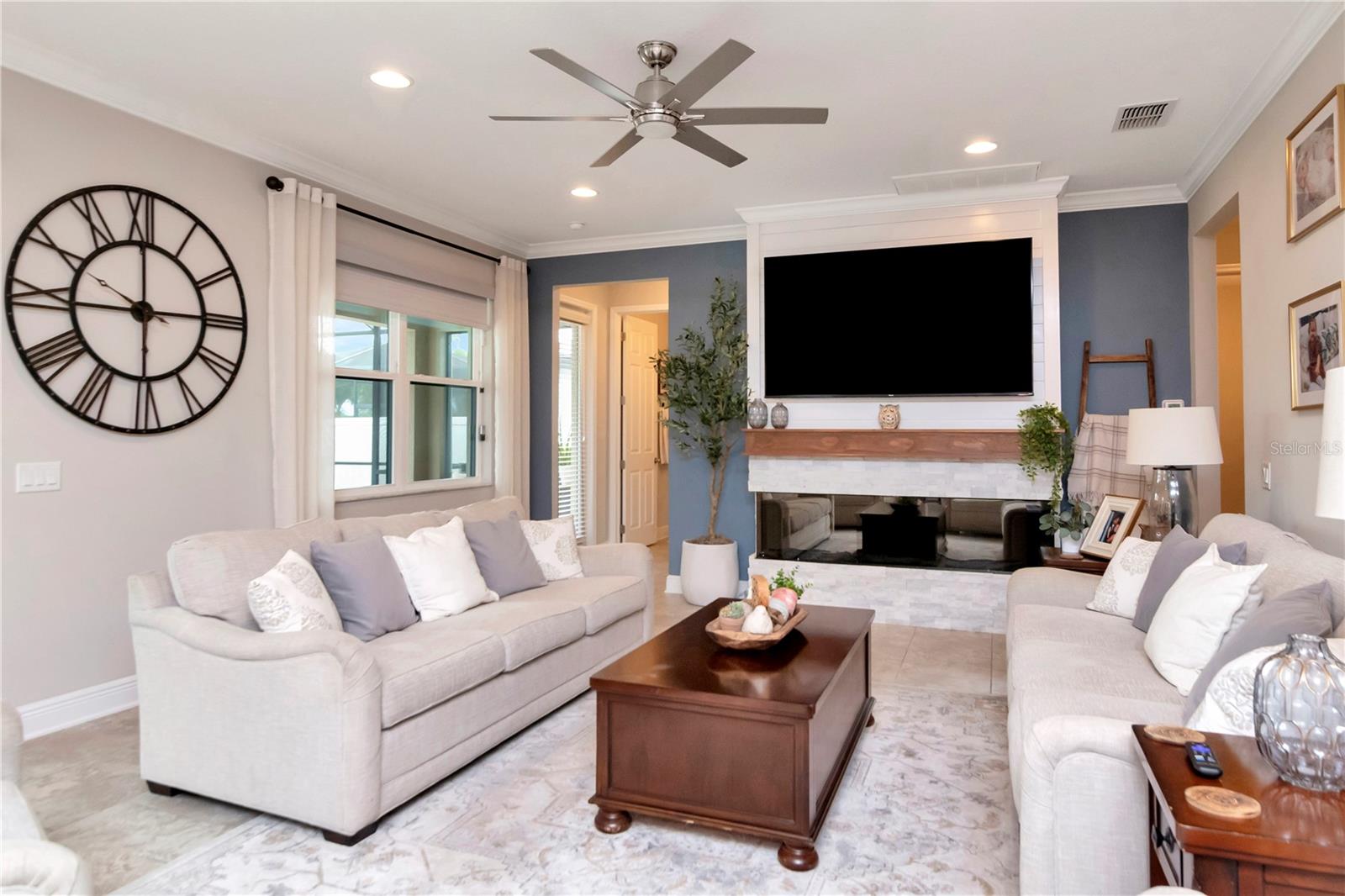 Custom Fireplace with ledger stone, shiplap, wood mantel, and a high-end smart electric fireplace