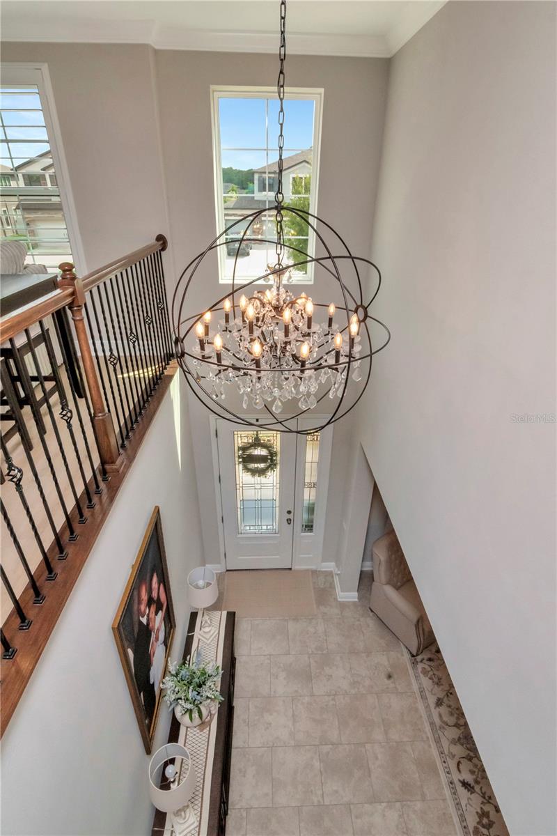 18-light crystal chandelier gracing the two-story foyer